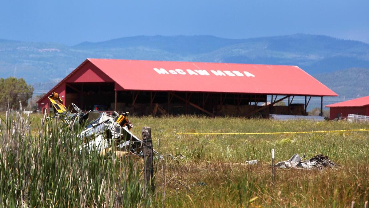 The wreckage of a World War II-vintage P-51 Mustang lies in a field Friday near Durango, Colo. Two people were killed in the crash, authorities say.