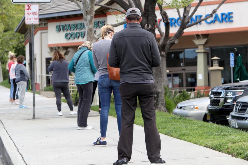 A long line of shoppers stood in line out to Gould Ave. to get into Trader Joe's grocery store on Foothill Blvd, in La Canada Flintridge on Tuesday, April 7, 2020. One man who came out of the store said he stood in line for about 45 minutes.