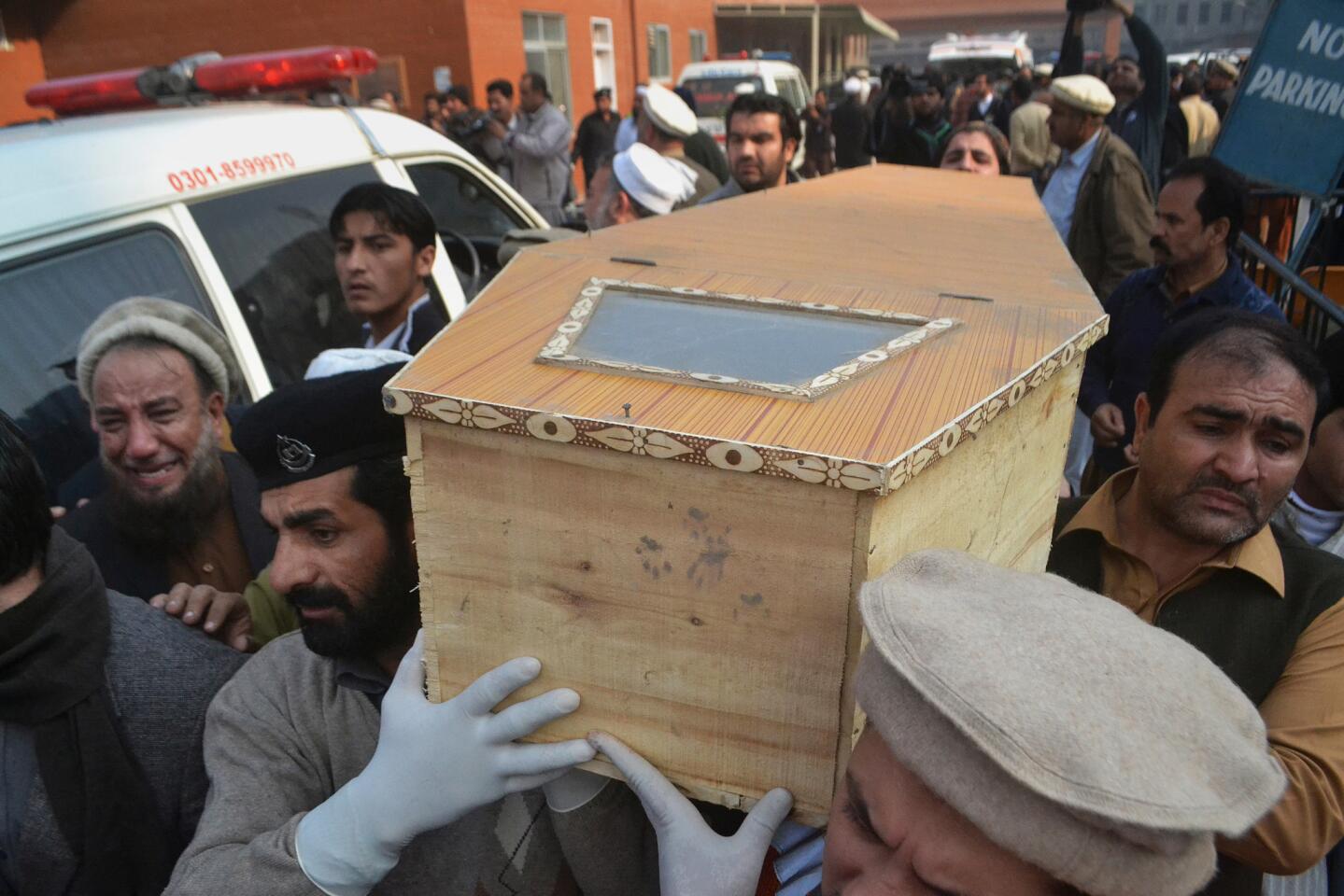 The casket of a Taliban attack victim is carried in Peshawar, Pakistan, on Tuesday.