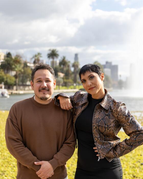 Sergio Lira and Lynette Coll pose for photos at Echo Park Lake on Friday, Feb. 9, 2024.