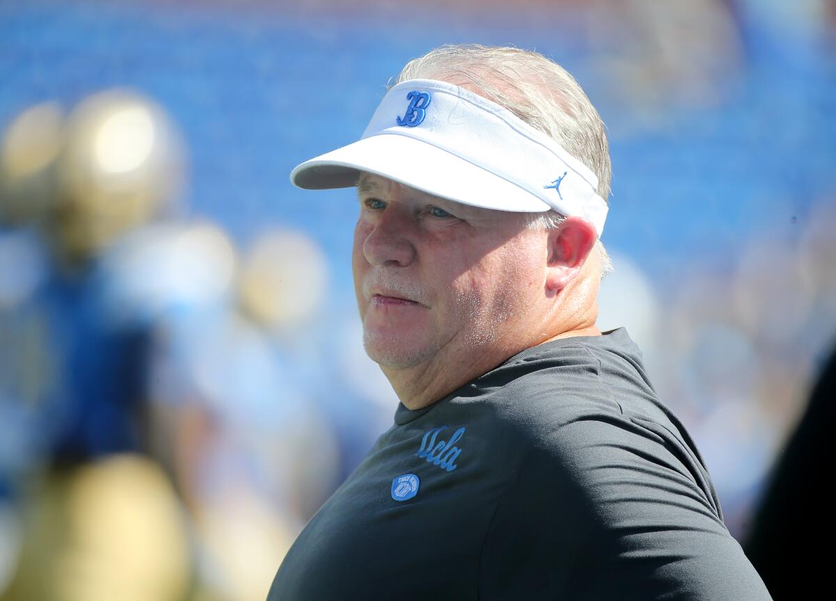 UCLA coach Chip Kelly watches his players warm up before a win over Washington State on Saturday.