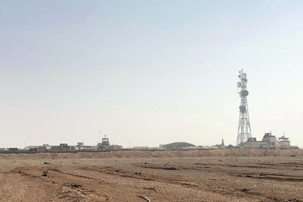 A tower above a complex amid a desolate desert landscape
