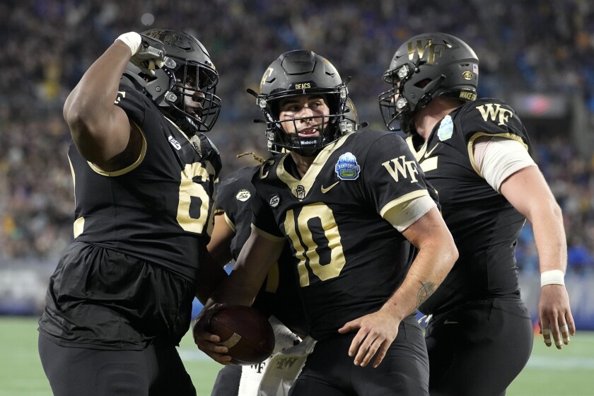 Wake Forest quarterback Sam Hartman (10) celebrates after scoring against Pittsburgh during the first half of the Atlantic Coast Conference championship NCAA college football game Saturday, Dec. 4, 2021, in Charlotte, N.C. (AP Photo/Chris Carlson)