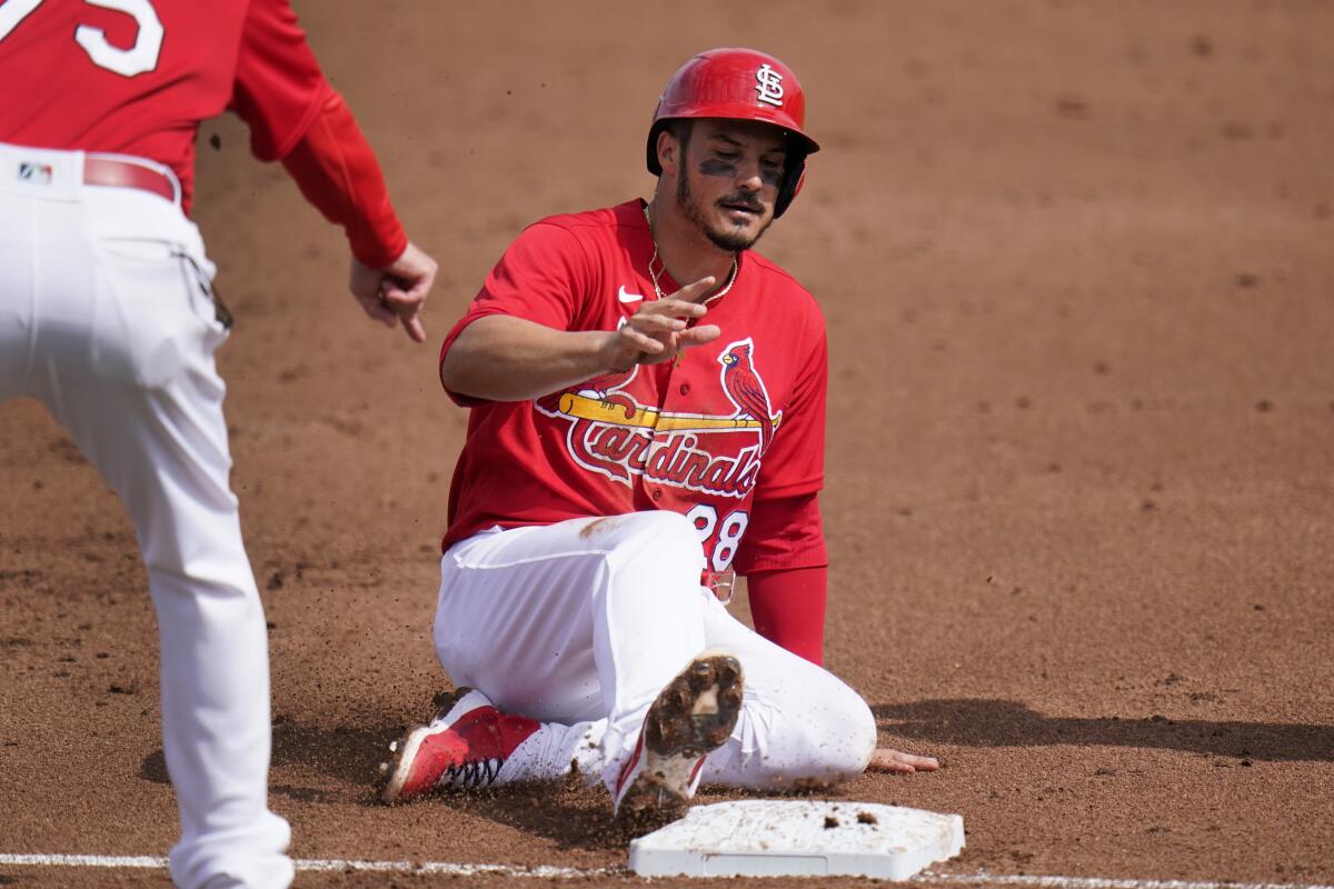 St. Louis Cardinals' Nolan Arenado slides safely into third after advancing on a throwing error by New York Mets catcher Tomas Nido during the first inning of a spring training baseball game Wednesday, March 3, 2021, in Jupiter, Fla. (AP Photo/Jeff Roberson)