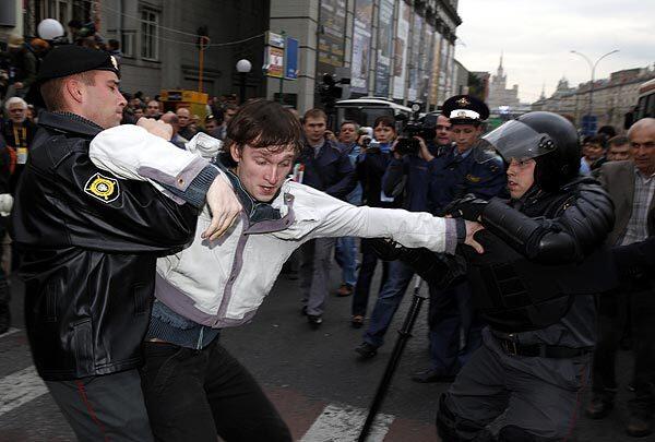 Riot police arrest an opposition demonstrator in Triumfalnaya Square in Moscow a day after Prime Minister Vladimir Putin suggested that protesters who gather routinely in central Moscow should "have a club on the head."
