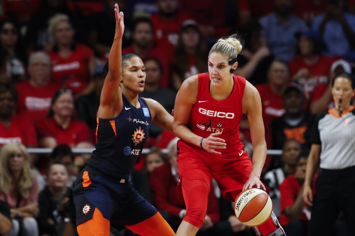 FILE - Washington Mystics forward Elena Delle Donne, right, drives against Connecticut Sun forward Alyssa Thomas during the first half of Game 5 of basketball's WNBA Finals, Oct. 10, 2019, in Washington. Delle Donne is ready to play again. The two-time WNBA MVP has only been able to play three games the last two seasons because of back issues that required surgery and potential complications if she got the coronavirus. “I’ll be ready. I feel phenomenal. I have been going to work every single day," Delle Donne said Tuesday, Feb. 1. (AP Photo/Alex Brandon, File)