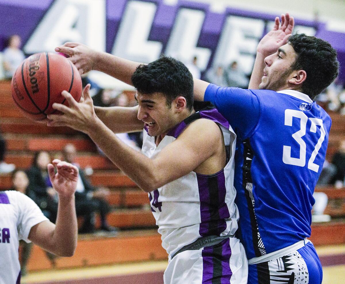 Hoover's David Khourdadjian pulls down a rebound against Burbank's Armen Nazarian in a Pacific League boys' basketball game at Hoover High School on Friday, January 3, 2020.