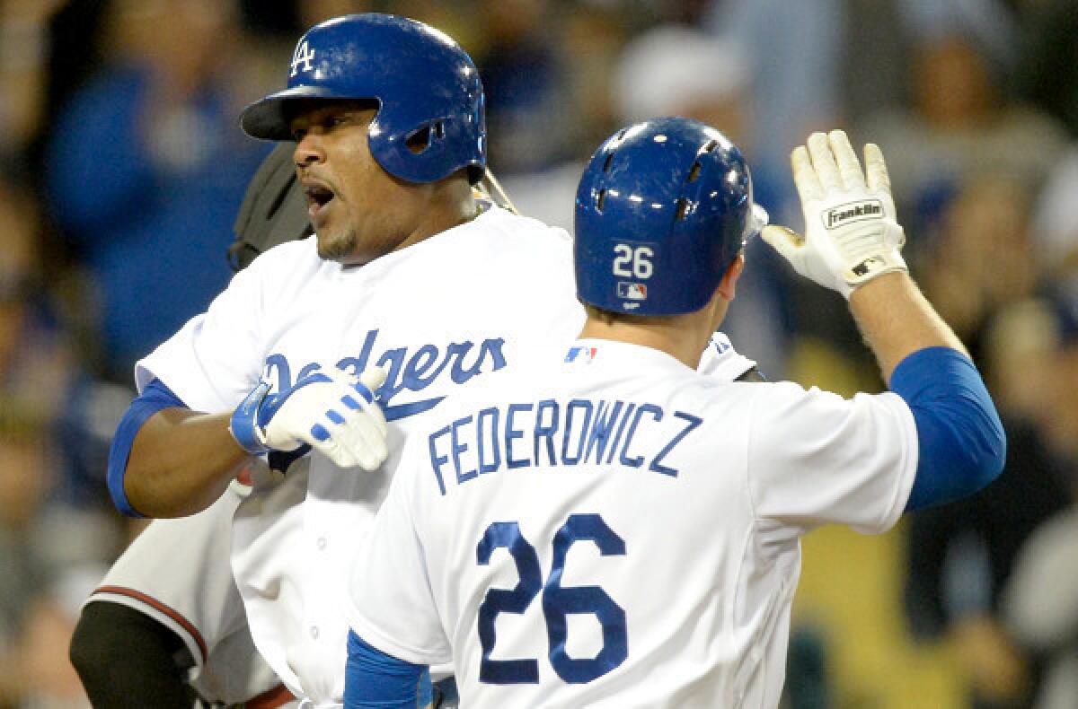 Dodgers third baseman celebrates with catcher Tim Federowicz after hitting a home run in the bottom of the ninth inning against the Diamondbacks to send the game into extra innings.