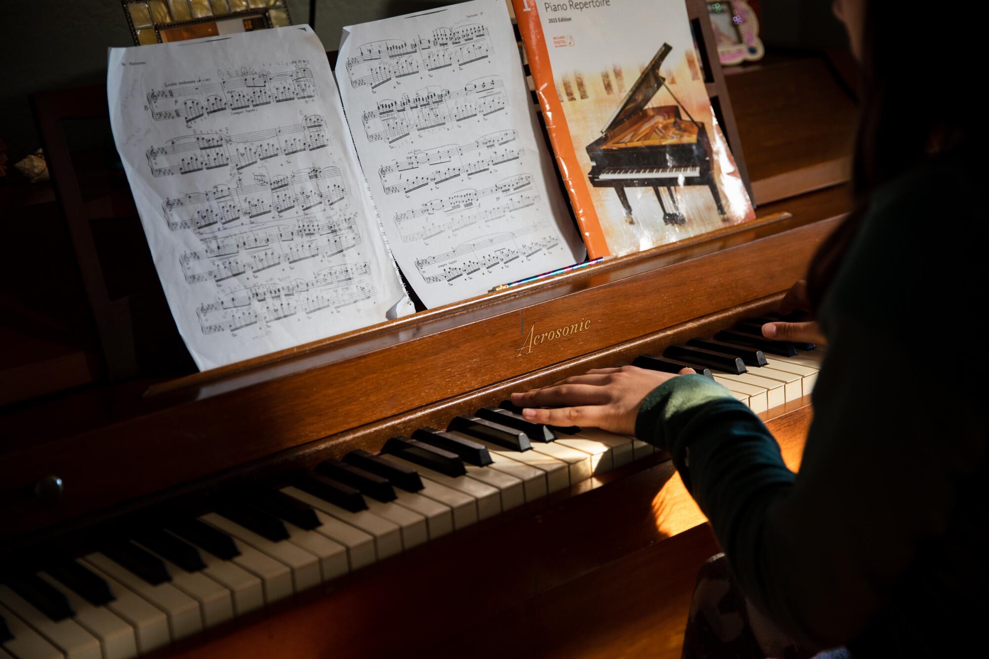 Vishaala Wilkinson practices playing the piano during an online class.