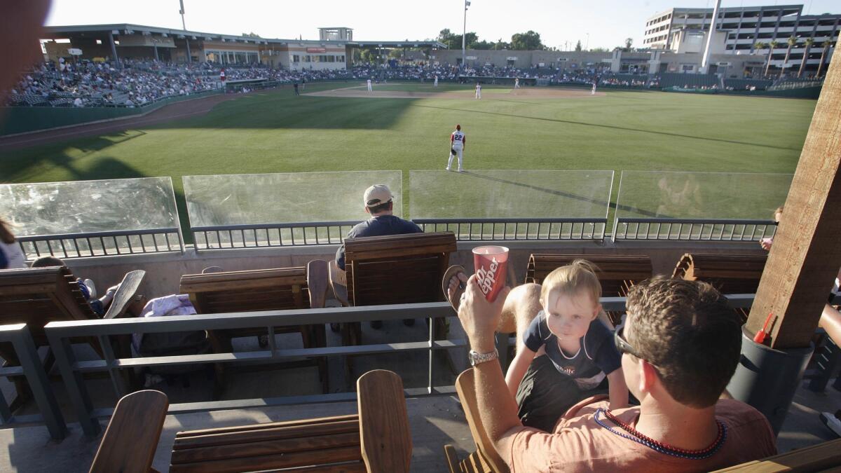 A father and child in the right field seats at Banner Island Ballpark, home of the Stockton Ports minor league baseball team.