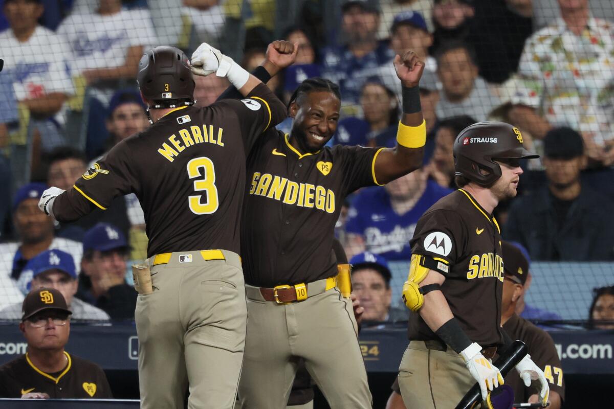 San Diego’s Jackson Merrill, left, celebrates with teammate Jurickson Profar after hitting a home run.