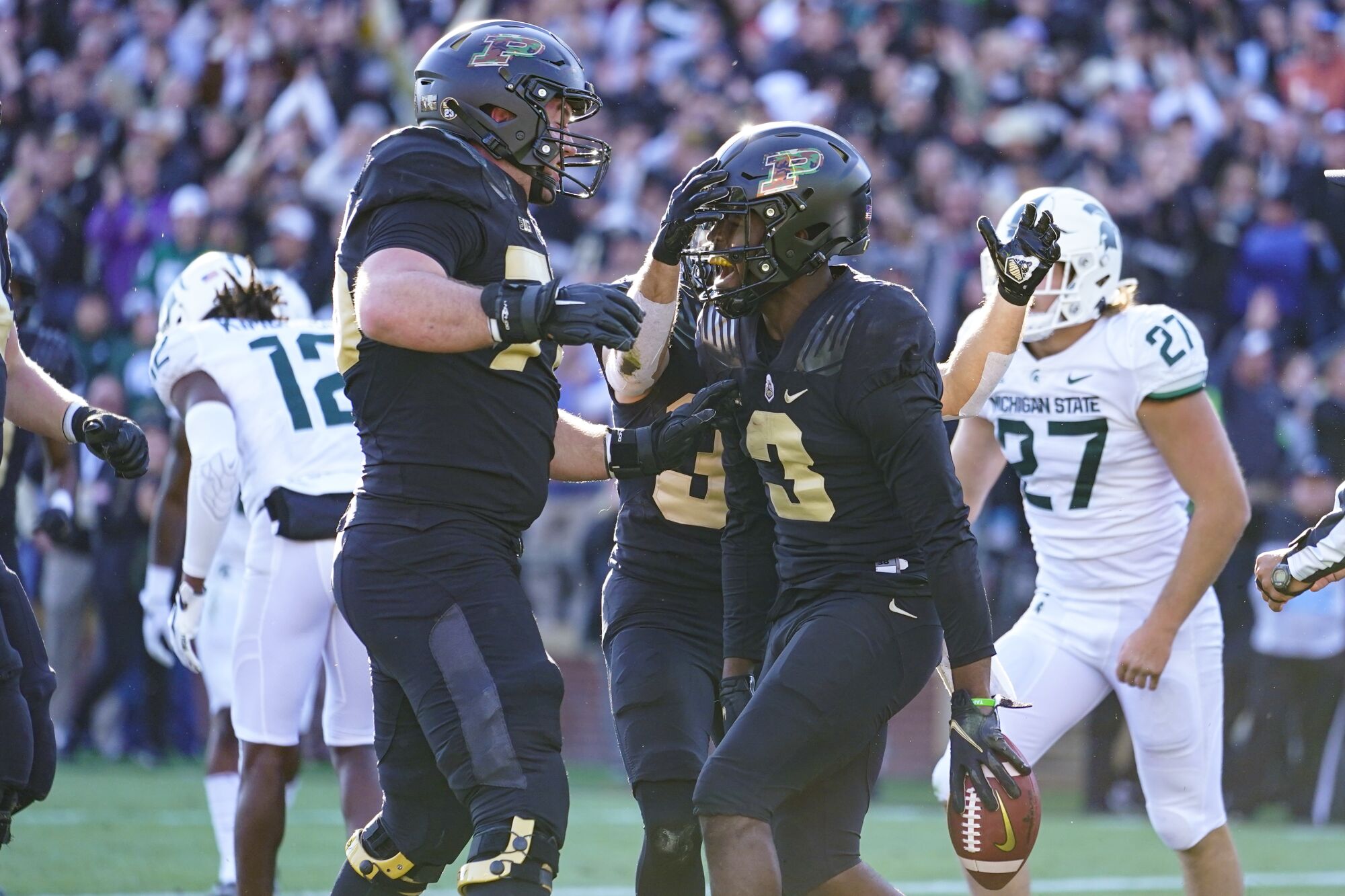 Purdue wide receiver David Bell celebrates a touchdown with offensive lineman Spencer Holstage.