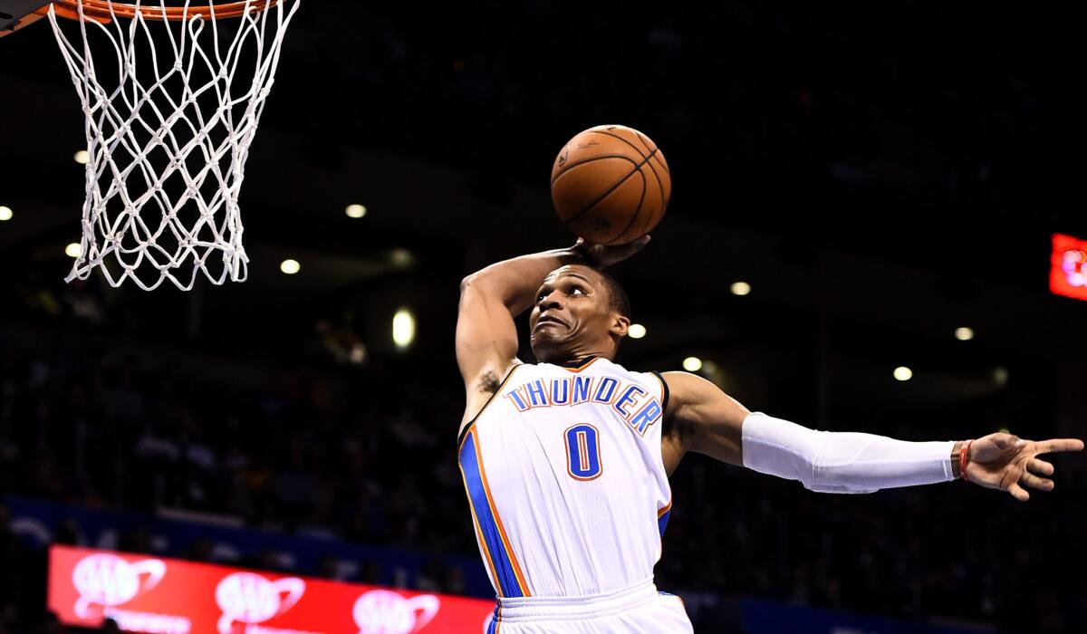 Thunder point guard Russell Westbrook takes aim at a dunk in the second half of a victory over the Warriors on Friday night in Oklahoma City.