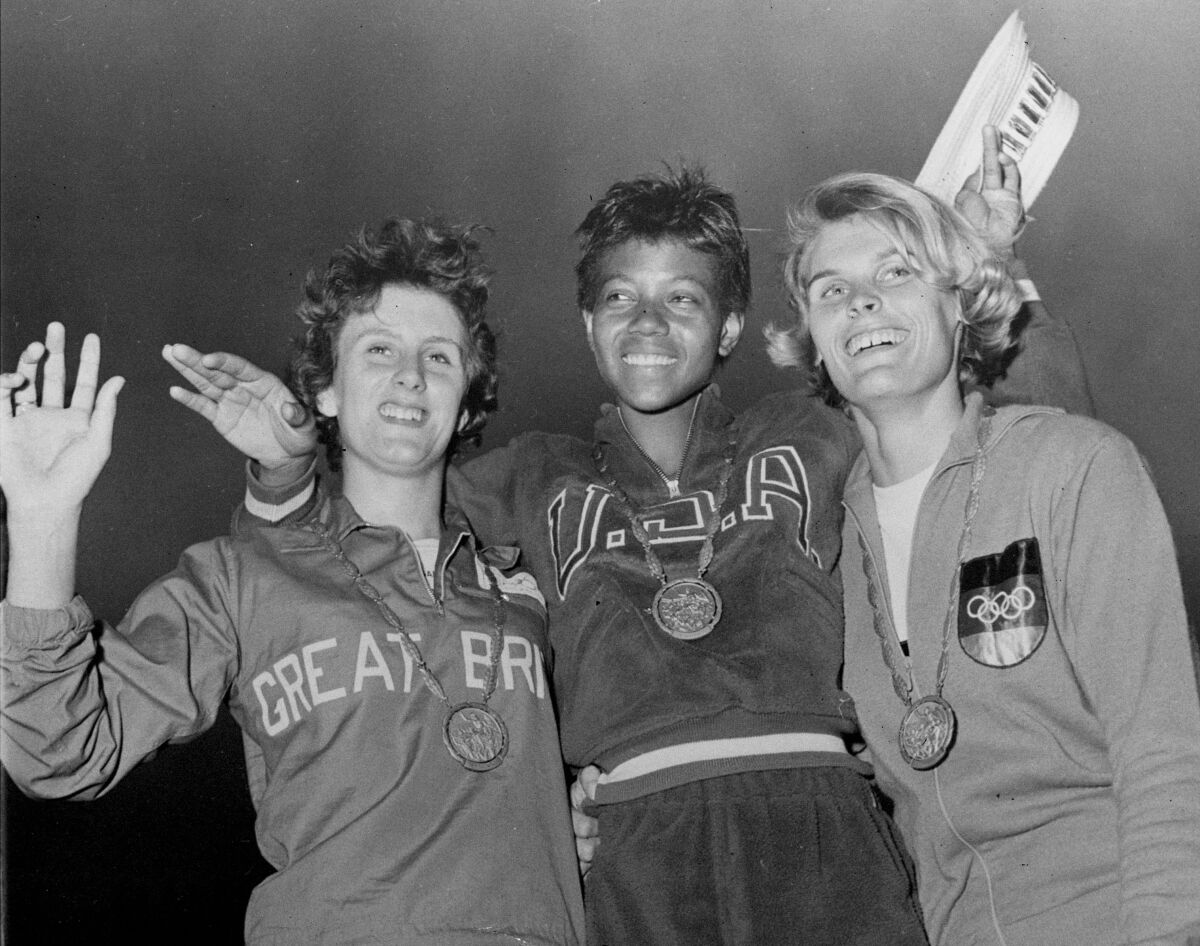 FILE - In this Sept. 5, 1960, file photo, the medalists in the women's 200-meter event, from left, bronze medalist Dorothy Hyman, of Great Britain; gold medalist Wilma Rudolph, of the United States, and silver medalist Jutta Heine, of Germany, pose with their medals at the Olympic stadium in Rome, Italy. It has been 50 years since Title IX was signed into law by President Nixon. The measure barred discrimination against women when it came to programs that receive federal assistance. (AP Photo/File)