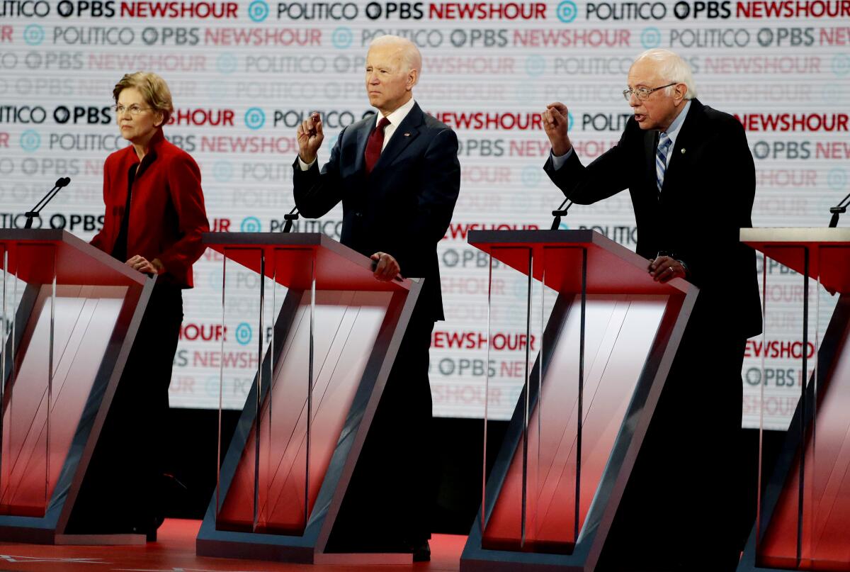 Elizabeth Warren, Joe Biden and Bernie Sanders on the debate stage