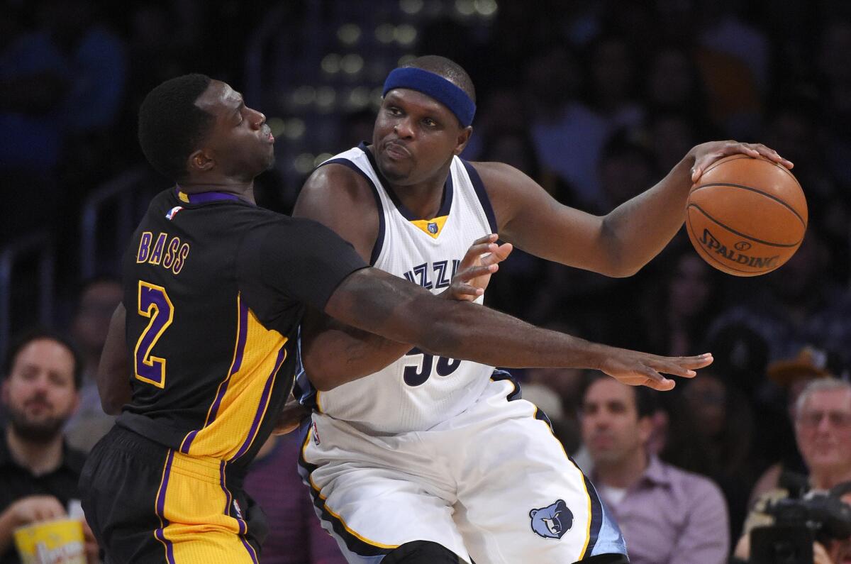 Lakers forward Brandon Bass, left, tries to knock the ball from the grasp of Grizzlies forward Zach Randolph during a game Feb. 26 at Staples Center.