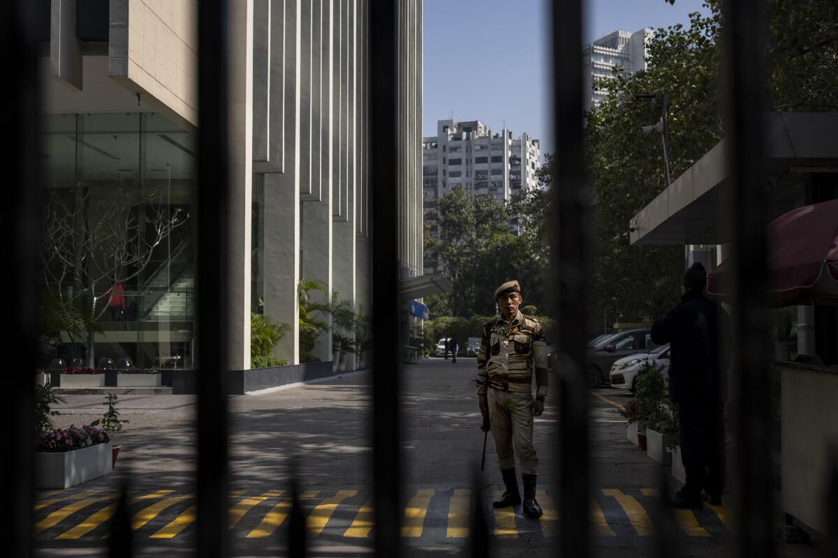 Armed security guard seen between bars