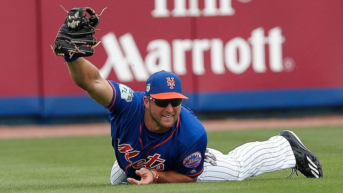 Mets left fielder Tim Tebow makes a diving catch on a fly ball in the second inning of a spring training game on Mar. 13.