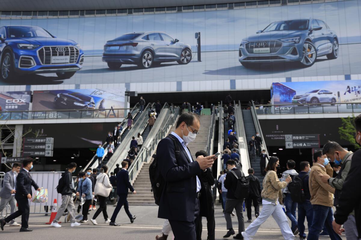 FILE - Visitors attend the Shanghai Auto Show in Shanghai on Wednesday, April 21, 2021. China’s auto sales rose by a lackluster 3.4% over a year earlier in the first half of 2022 as anti-virus controls kept buyers away from dealerships, but demand in the industry’s biggest global market rebounded in June, an industry group reported Monday, July 11, 2022. (AP Photo/Ng Han Guan, File)
