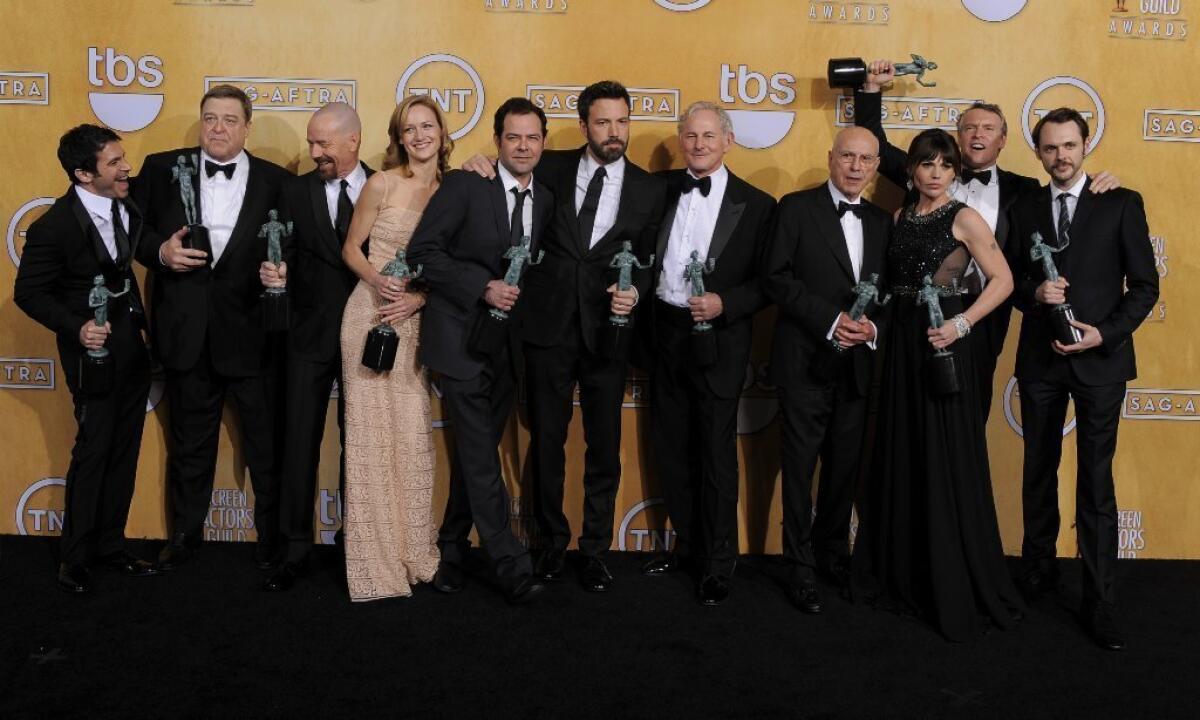 The cast of "Argo" poses backstage with the award for performance by a cast in a motion picture at the 19th Screen Actors Guild Awards.