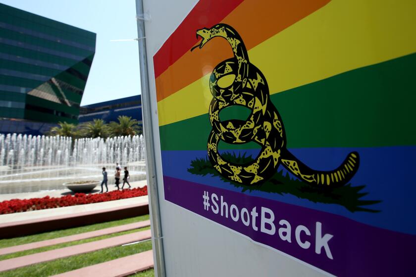 A poster featuring a rainbow-colored version of the Gadsden flag and the hashtag #ShootBack in front of the Pacific Design Center in West Hollywood.