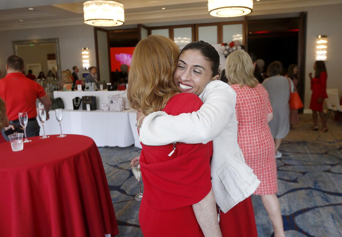 Dareen Khatib, board member, greets a friend during the Orange County "Be the Beat" Go Red for Women.