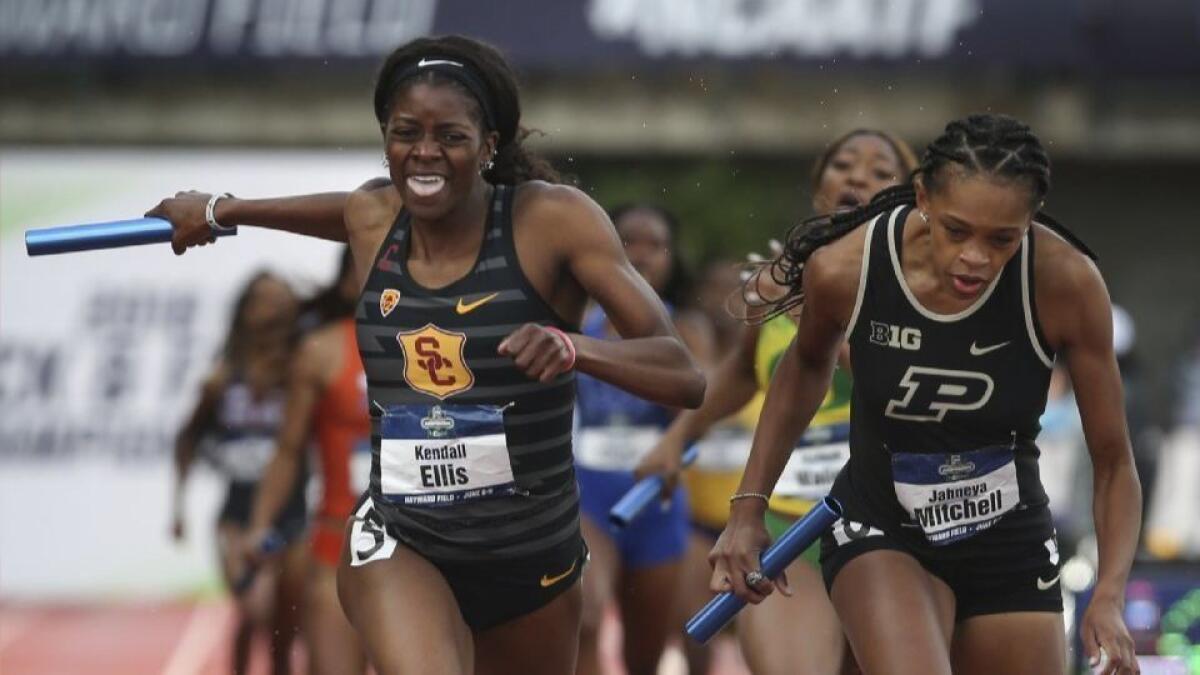 USC's Kendall Ellis crosses the finish line first ahead of Purdue's Jaheya Mitchel in the women's 4x400 meter relay, delivering and incredible comeback for the Trojans' relay team at the NCAA championships.