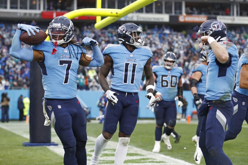 Tennessee Titans running back D'Onta Foreman (7) and quarterback Ryan Tannehill, right, celebrate after Foreman scored a touchdown against the Miami Dolphins in the first half of an NFL football game Sunday, Jan. 2, 2022, in Nashville, Tenn. (AP Photo/Wade Payne)