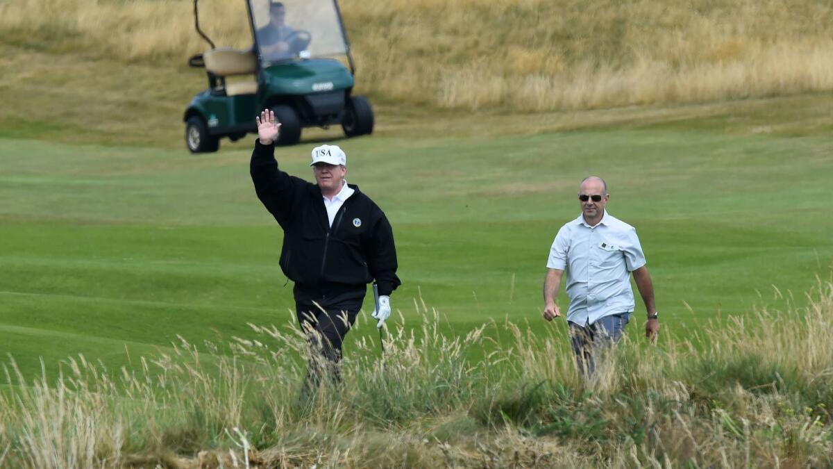 President Trump waves as he plays a round of golf on the Ailsa course at Trump Turnberry, his luxury golf resort in Scotland, on July 14, 2018.