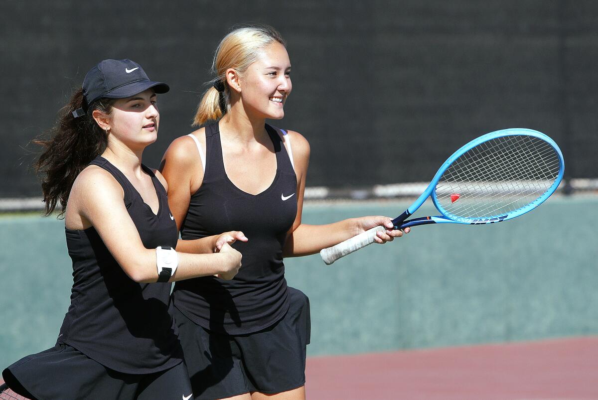 Glendale's Celine Khachiki and Momo Guzman congratulate each other after winning a point in a second round doubles match against Arcadia in the Pacific League girls' tennis semifinals and finals at Burroughs High School on Wednesday, October 30, 2019. A couple of the contests were second-round contests, played today because of poor air quality on Monday.