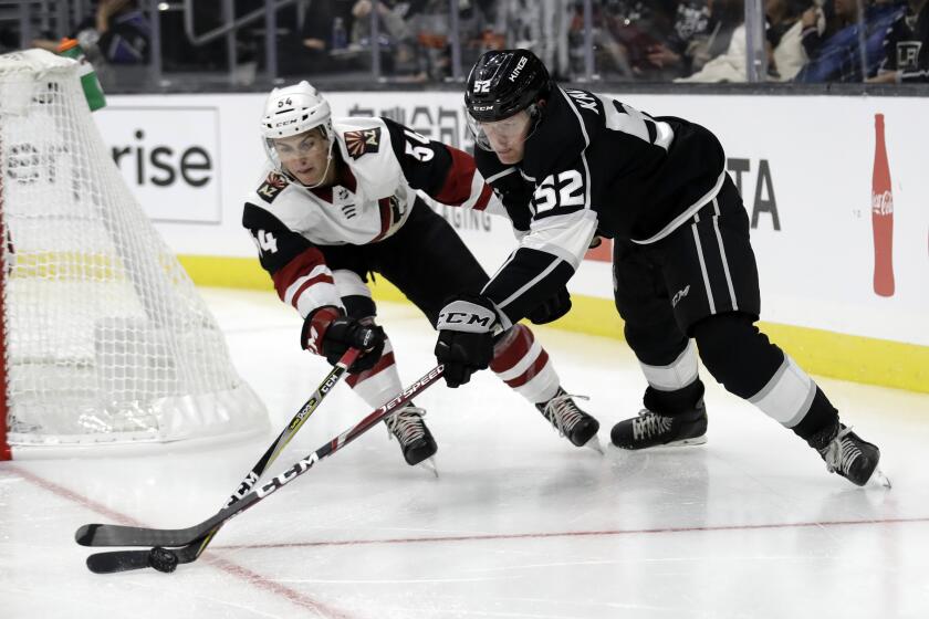 Los Angeles Kings' Arthur Kaliyev, right, is defended by Arizona Coyotes Cam Dineen during the second period of a preseason NHL hockey game Tuesday, Sept. 17, 2019, in Los Angeles. (AP Photo/Marcio Jose Sanchez)
