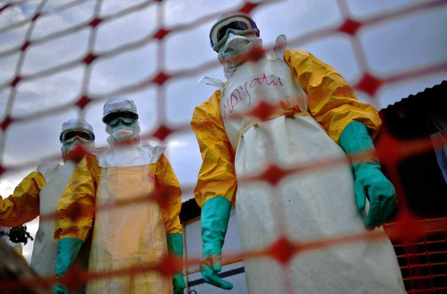 Medecins Sans Frontieres medical staff members wearing protective clothing treat the body of an Ebola victim at their facility in Kailahun, Sierra Leone, on Aug. 14, 2014.