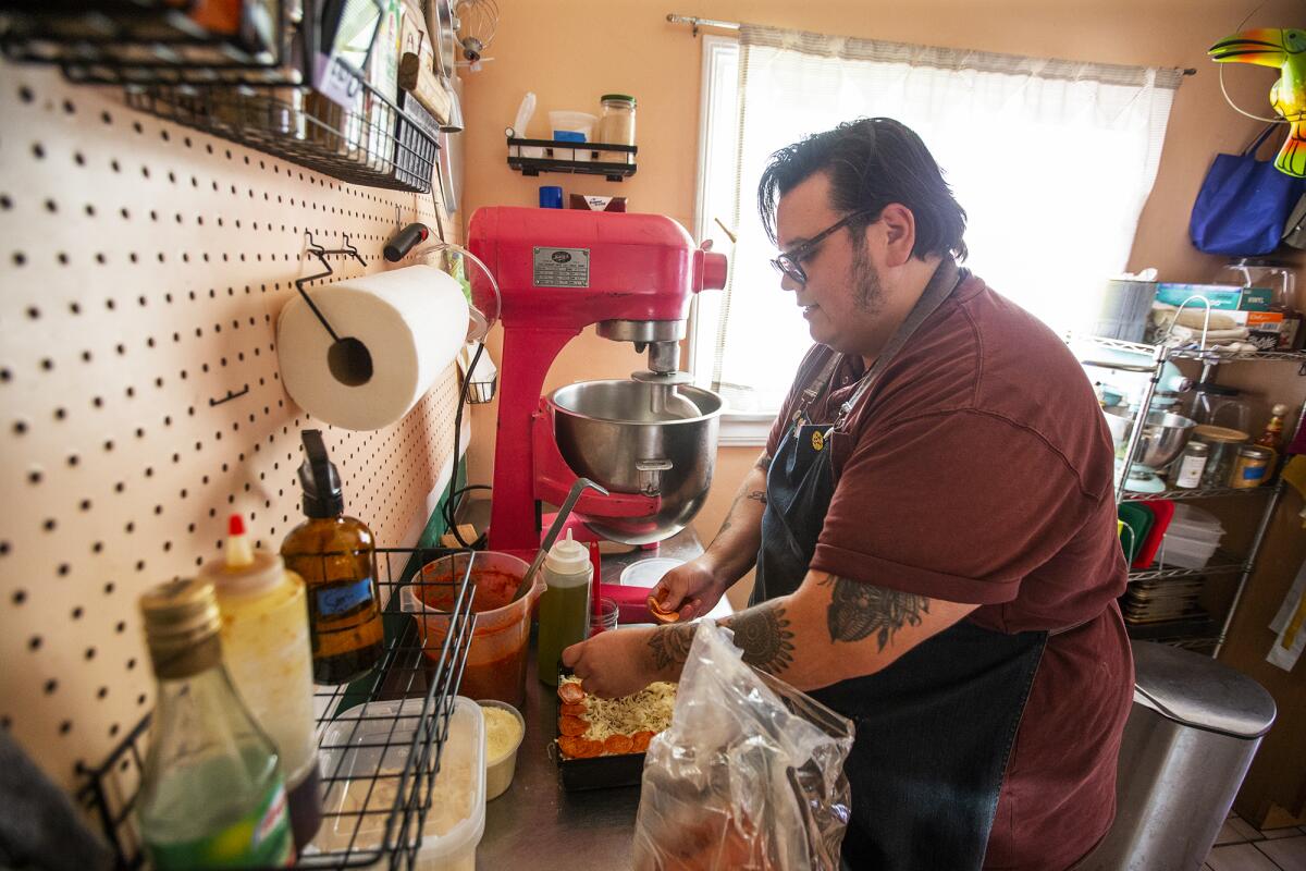 Derek Bracho makes homemade focaccia-bread pizza at his home in Anaheim on Thursday, Sept. 30.