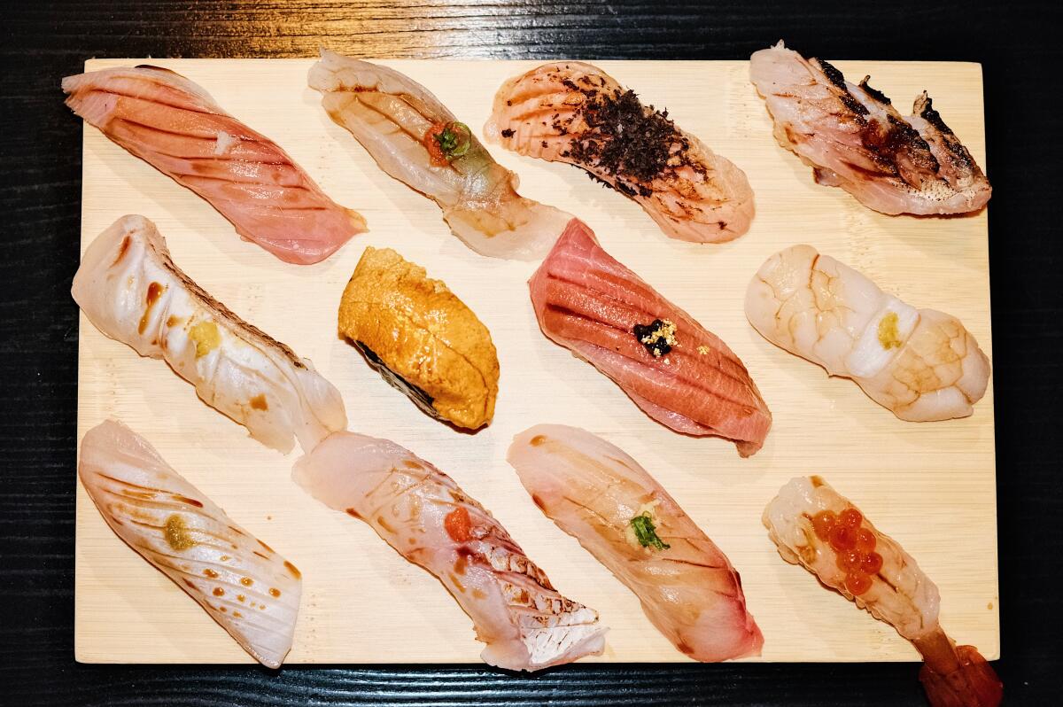 A closeup overhead photo of a 12-piece nigiri omakase at Hato Sushi in Koreatown.