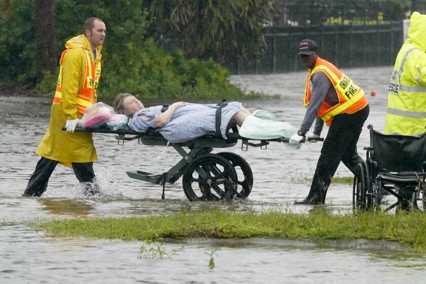 Authorities transport a person out of the Avante nursing home in the aftermath of Hurricane Ian, Thursday, Sept. 29, 2022, in Orlando, Fla. Hurricane Ian carved a path of destruction across Florida, trapping people in flooded homes, cutting off the only bridge to a barrier island, destroying a historic waterfront pier and knocking out power to 2.5 million people as it dumped rain over a huge area on Thursday. (AP Photo/John Raoux)