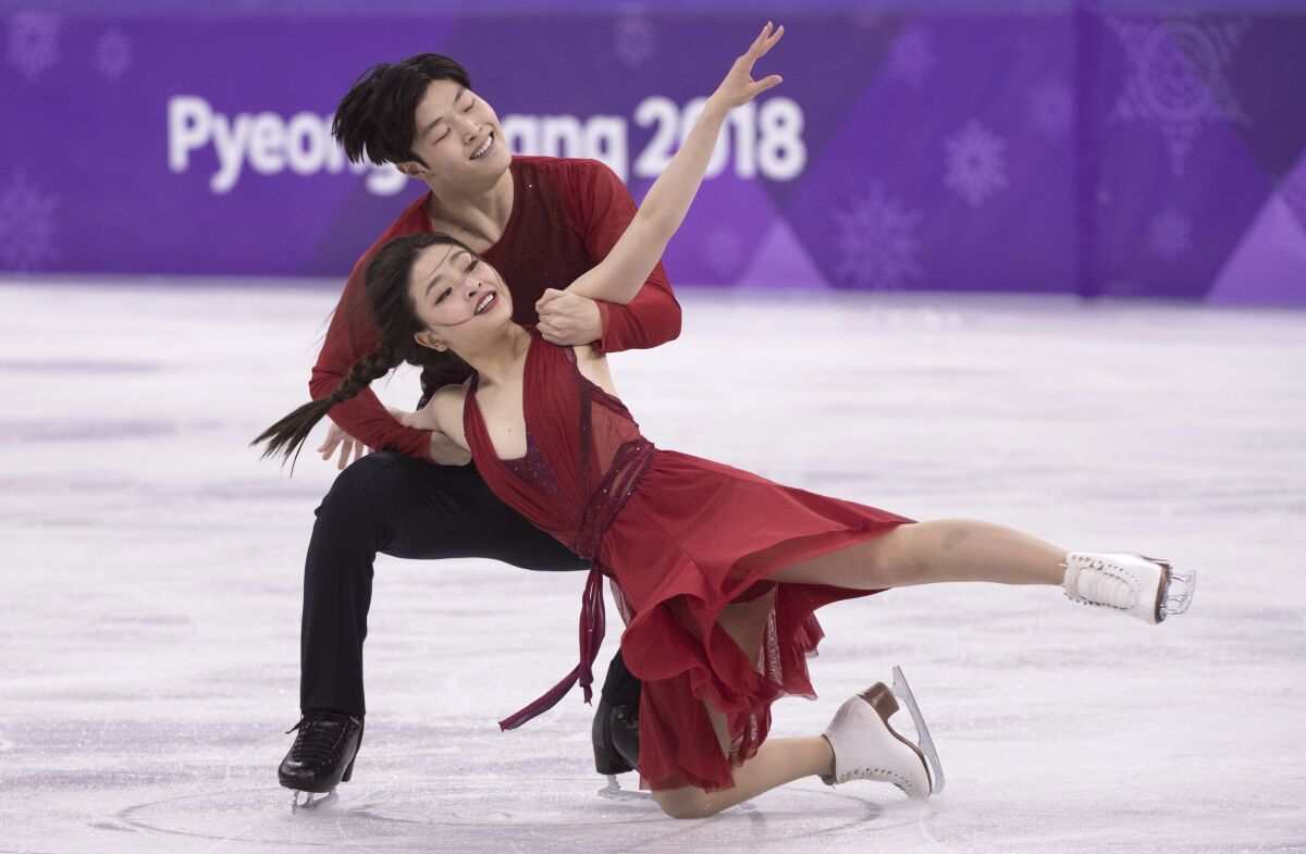 FILE - Maia Shibutani and Alex Shibutani, of the United States, perform in the ice dance figure skating free program at the Pyeongchang Winter Olympics. Feb. 20, 2018, in Gangneung, South Korea. The Olympic ice dancers along with Paul E. George, who served as the director of the U.S. Olympic Committee, were elected to the U.S. Figure Skating Hall of Fame on Thursday, Dec. 1, 2022. (Paul Chiasson/The Canadian Press via AP, File)