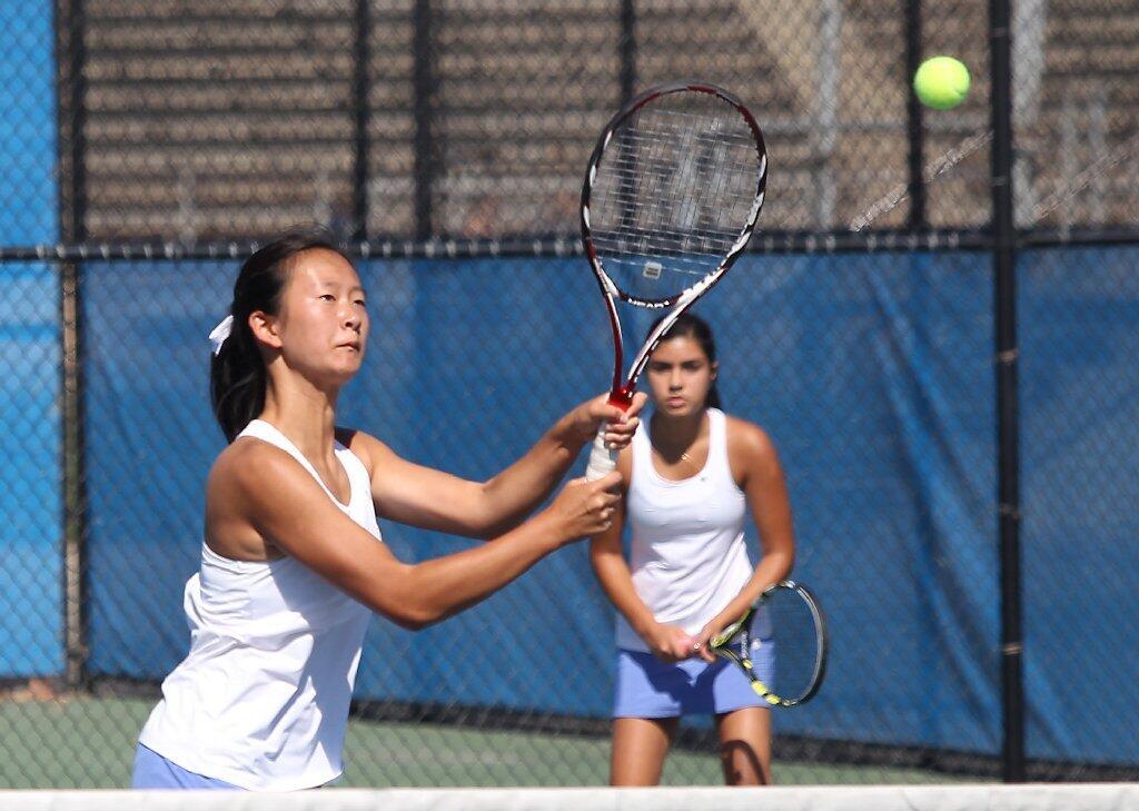 Corona del Mar High No. .1 doubles team of Erica Chen, left, and Camella Edalat win a point against Newport Harbor in the Battle of the Bay at Newport Harbor on Thursday.