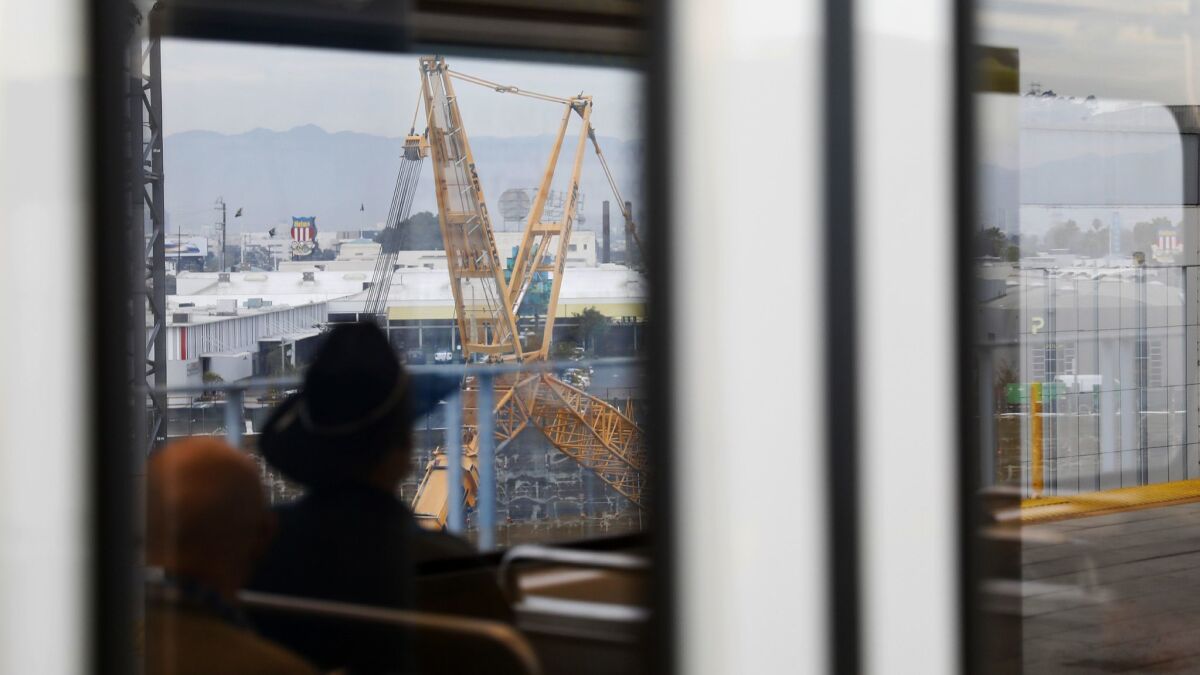 Construction is seen through a window as Metro passengers pass through Culver City in January 2018.