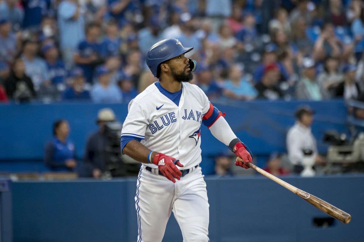 Toronto Blue Jays right fielder Teoscar Hernandez (37) watches his home run during the fourth inning of a baseball game against the Philadelphia Phillies, Wednesday, July 13, 2022 in Toronto. (Christopher Katsarov/The Canadian Press via AP)