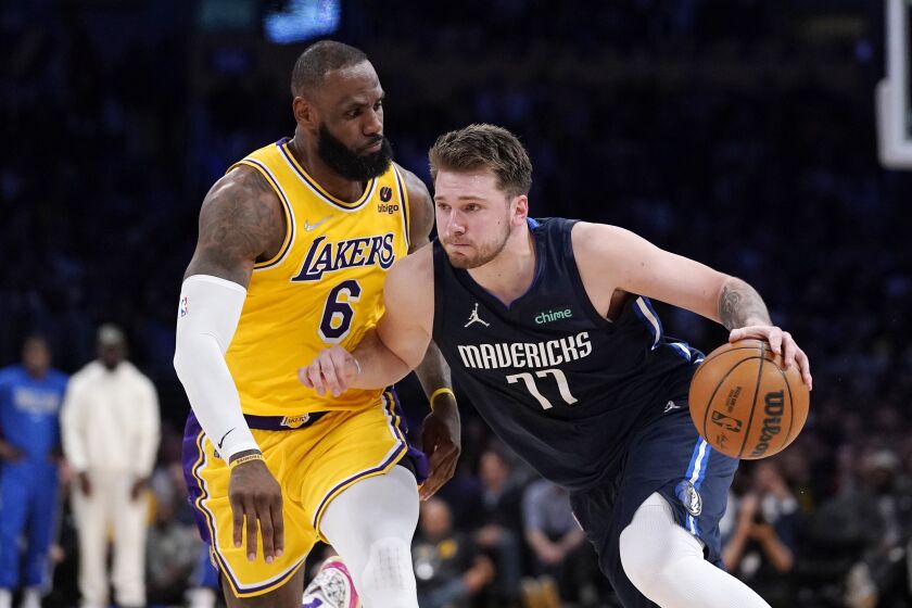 Dallas Mavericks guard Luka Doncic, right, drives past Los Angeles Lakers forward LeBron James during the second half of an NBA basketball game Tuesday, March 1, 2022, in Los Angeles. (AP Photo/Mark J. Terrill)