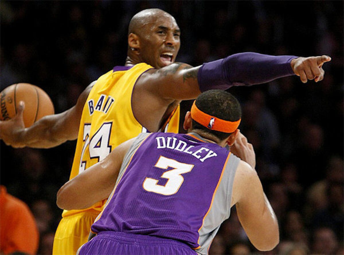 Kobe Bryant directs the offense as Jared Dudley defends.