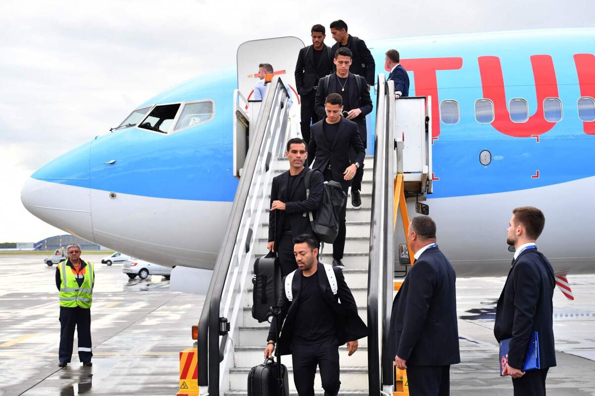 Mexico's national football team players disembark from a plane at the Sheremetevo airport, outside Moscow city centre, on June 11, 2018, ahead of the Russia 2018 World Cup.