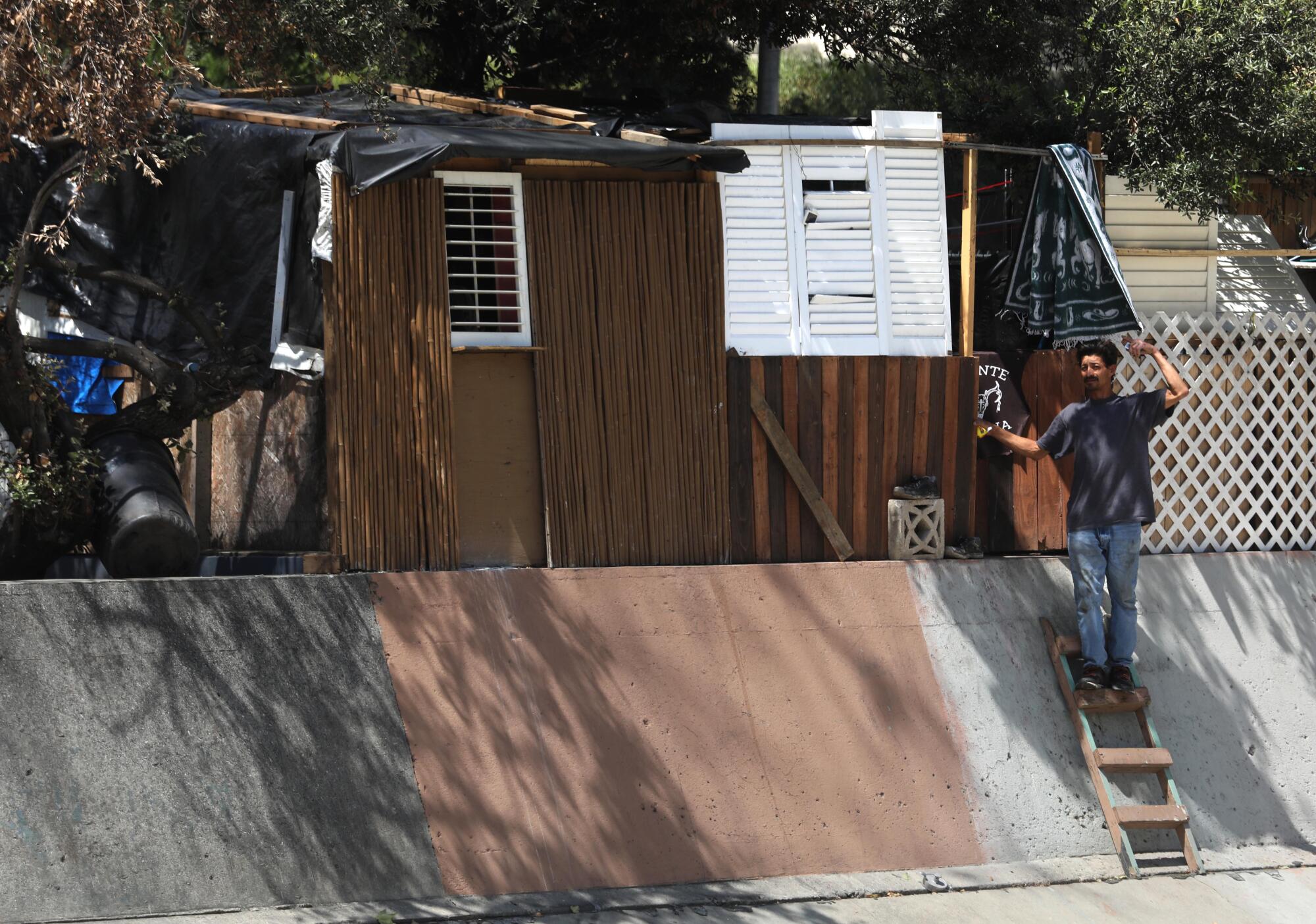 Cesar Augusto stands in front of his home. He arrived in Los Angeles roughly 20 years ago from Guatemala. 