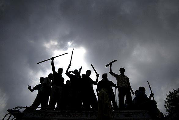 Hindu activists shout anti-government slogans during a protest in Jammu, India, on Monday. The protests were sparked by the recent transfer of 99 acres of land by the state government to the Shri Amarnath Shrine Board, a trust running a Hindu shrine, to build facilities for the hundreds of thousands of pilgrims who flock there every year.