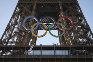FILE - The Olympic rings are mounted on the Eiffel Tower Friday, June 7, 2024 in Paris.