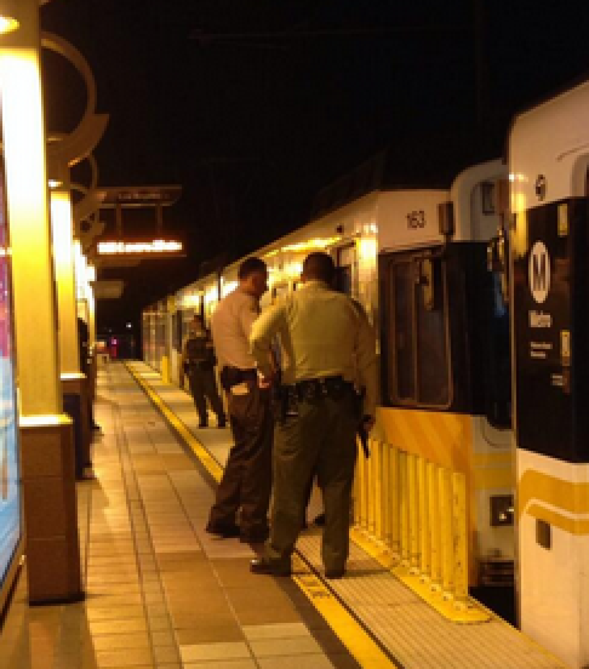 Deputies search the Metro Blue Line after someone reported three juveniles armed with guns Tuesday. No weapons were found.