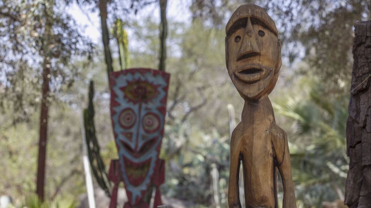 Carved and painted wood tiki figures decorate artist Bosko Hrnjack's Escondido ranch.