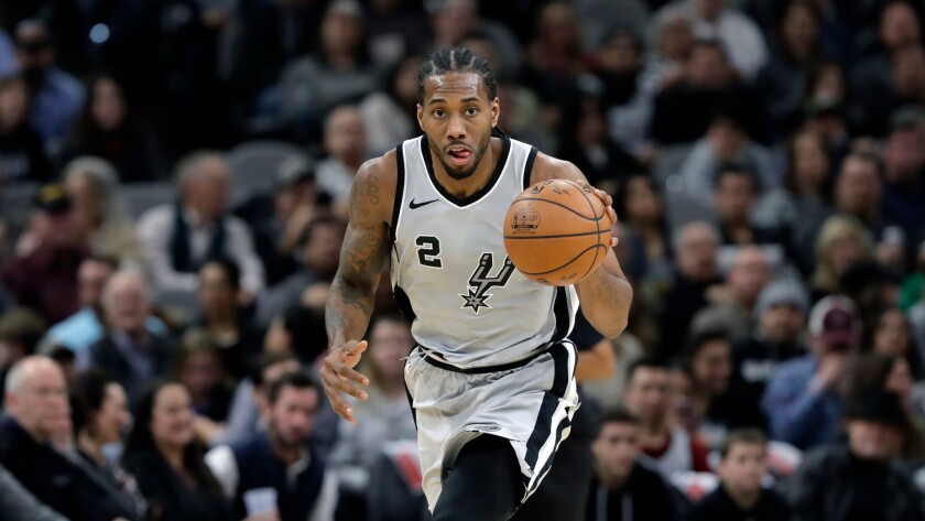 In this Jan. 13, 2018, file photo, San Antonio Spurs forward Kawhi Leonard (2) moves the ball up court during the second half of an NBA basketball game against the Denver Nuggets, in San Antonio.