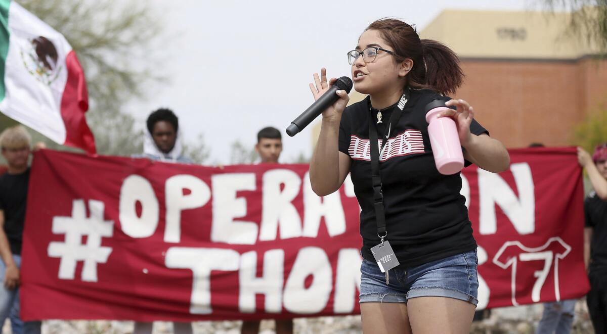 Quiriat Rosas, 17, speaks to the crowd after students from Desert View High School marched to the Pima County Sheriff's Department in Tucson.