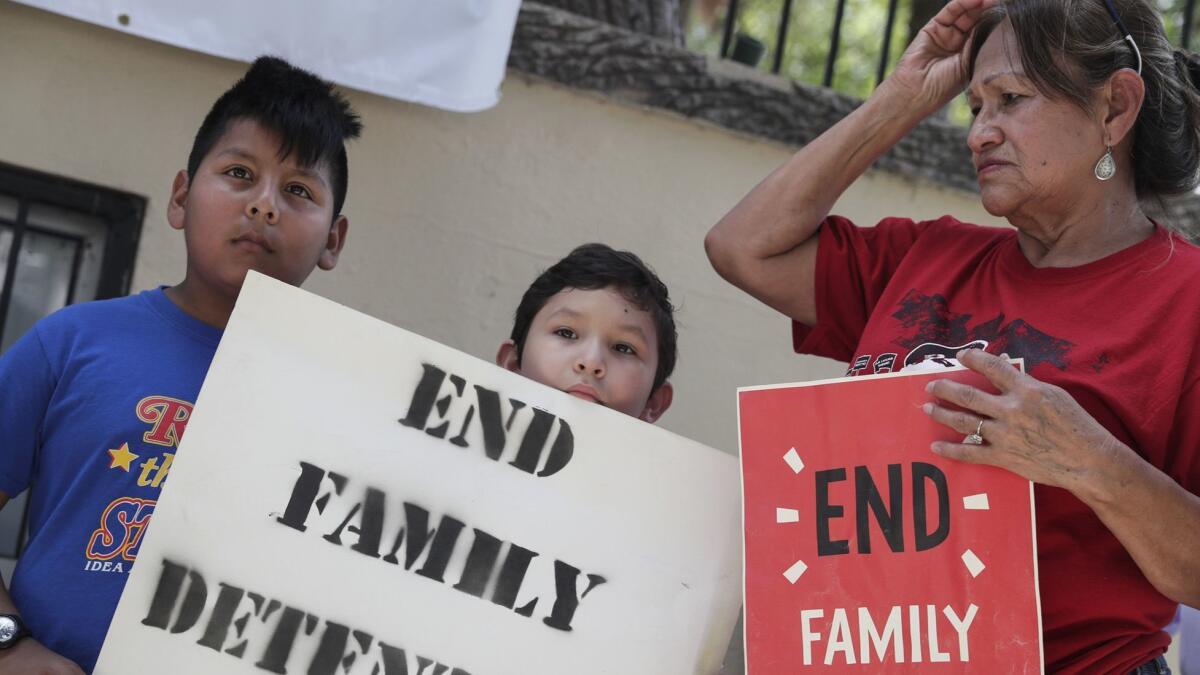 Edgar Ramirez, 11, Aaron Montes, 9, and Bertha Ozuna join demonstrators at Archer Park in McAllen, Texas, to support the #BreakBreadNotFamilies movement to change U.S. immigration policies.